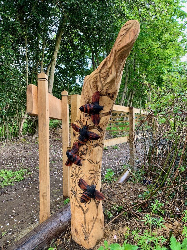 Wooden carving depicting bees